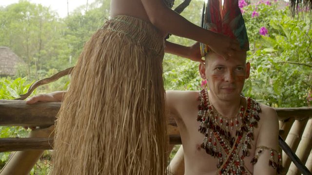 Caucasian Adult Man Dressed Up As Indigenous Being Crowned By A Indigenous Girl In Ecuador