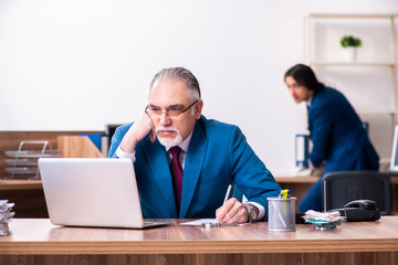 Young and old employees working together in the office