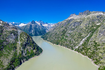 Fototapeta na wymiar Aerial view over a mountain lake at Grimsel pass in Switzerland