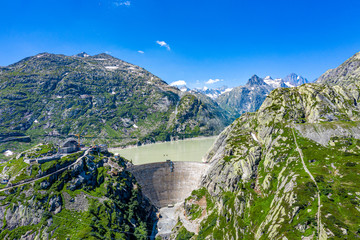 Mountain lake and dam in the Swiss Alps - Switzerland from above
