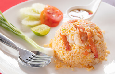 Fried rice with shrimp on white dish.