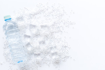 ice cubes and bottle of water on white table top view mock up