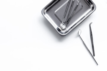 Dentist tools for cure teeth on white background top view copy space
