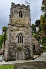 Fototapeta na wymiar Anglican St Just's Church tower in St Just in Roseland Cornwall England surrounded by palm trees