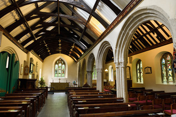 Interior of Anglican St Just's Church with stained glass windows and pipe organ St Just in Roseland...