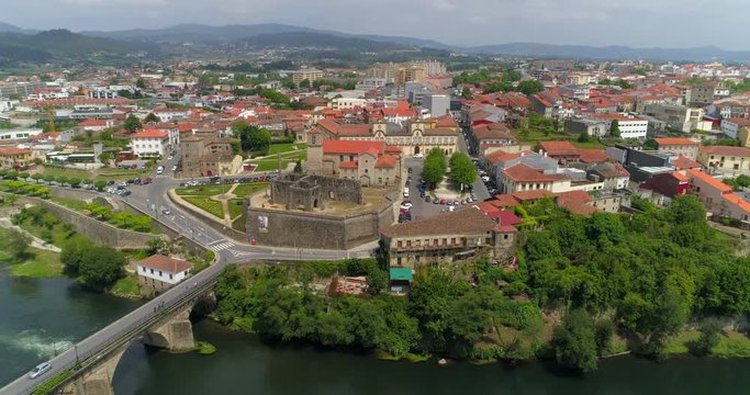 Aerial: Cars Drive Across Barcelos Bridge and Around Picturesque Landmarks Along the Banks of Cavado River - Barcelos, Portugal