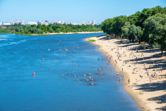People sunbathing on the beach of Sozh river in summer. Gomel, Belarus