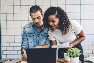 Two business people working and discussing strategy with laptop computer.creative business people planning and brainstorm in modern work loft.Teamwork concept