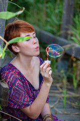 WOMAN SITTING ON A GANGWAY WITH BUBBLES.
