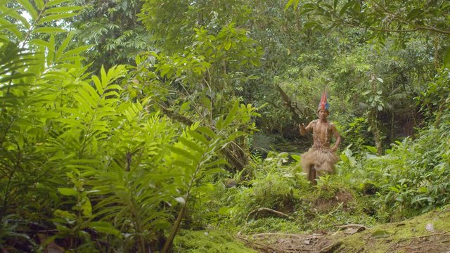Indigenous Warrior Running Through The Amazon Rainforest In Ecuador