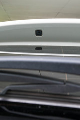 Luxury car rear windshield wiper spray nozzle.