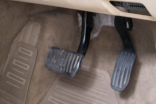 Luxury white car brake and acceleration pedals.