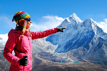 Hiking in Himalaya mountains. Woman Traveler with Backpack hiking in the Mountains. mountaineering...