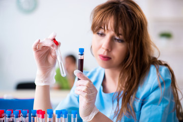 Young lab assistant testing blood samples in hospital