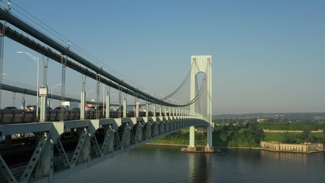 Hugging side of the Verrazanno Bridge while descending and panning up at the arch; smooth,dramatic and cinematic