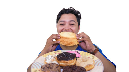 fat or overweight Asian man eating a lot of big unhealthy and sweet food on the plate isolated in white