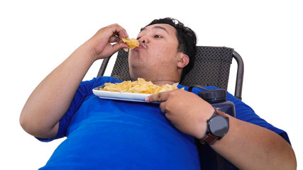 Portrait of lazy Overweight man eating chips and holding water container while laying on a  lazy chair