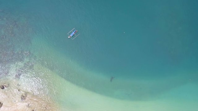 Beautiful top view of a boat in the blue sea