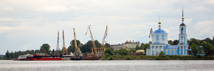 Fototapeta na wymiar Tver region, Kimry area, White town, Russia, Ship repair yard and Jerusalem Church on the banks of the Volga river, view from water on summer day