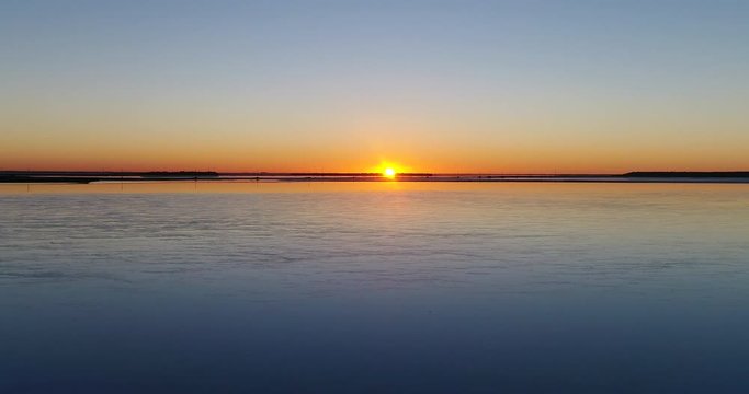 Panning over salt lake with sun