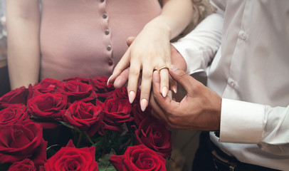 Obraz na płótnie Canvas Caucasian man putting on girl finger engagement ring.