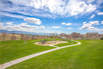 Park and houses on a residential area with mountain and lake in the background