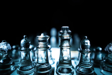 The concept of business competition: Close-up of a businessman holding a glass chess