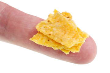 In the future we will eat this concept - small ugly bad  potato chips  crumbs  on finger isolated macro