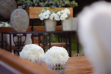 Bouquets of white flowers on a wooden table. Wedding decoration.