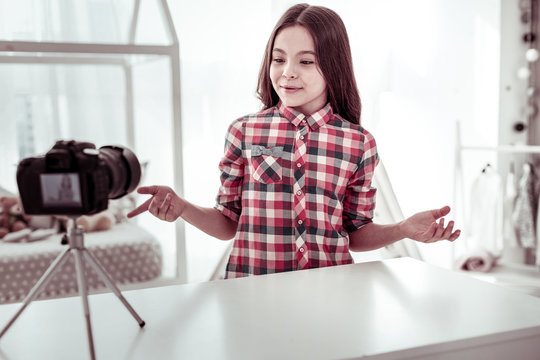 Joyful positive girl recoding a new video