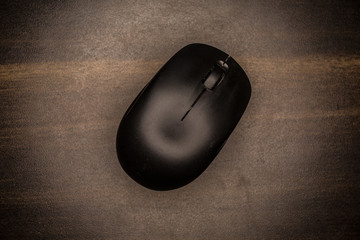 Top view of a black computer mouse on a table
