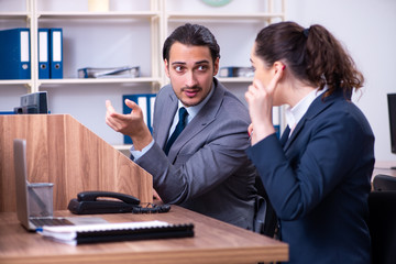 Two employees working in the office