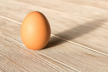 Chicken egg on a wooden table. Close up.
