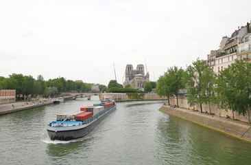 Fototapeta na wymiar Container tanker Seine river cityscape Paris France