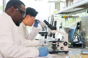 Scientist and students working in lab. Doctor teaching interns to make analyzing research. Biotechnology, chemistry, bacteriology, virology, dna and health care concept.