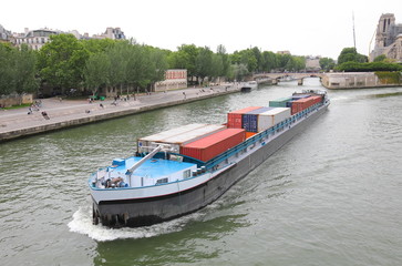 Fototapeta na wymiar Container tanker Seine river cityscape Paris France
