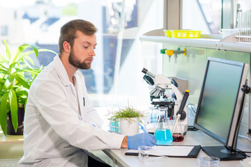 Scientist working in lab. Doctor making microbiology research. Laboratory tools: microscope, test tubes, equipment. Biotechnology, genetics, biochemistry, pharmaceutical, dna and health care.