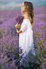 Little girl in a field with flowers. 