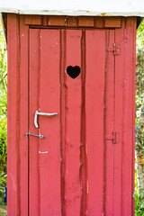 Outdoor toilet door with heart