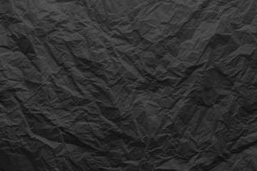 Crumpled paper texture. Black crumpled paper close-up.