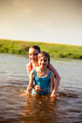 Fototapeta premium Children bathing in river on summer day.