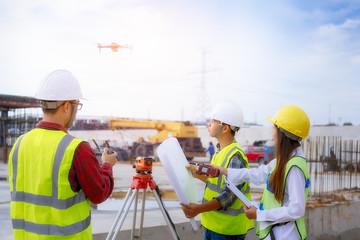 Drone operated by construction worker on building site,flying with drone. - 282186384