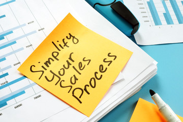 Simplify Your Sales Process written on the page. - obrazy, fototapety, plakaty