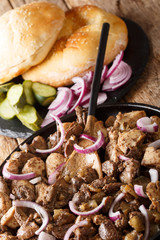 Jerusalem mixed grill (meorav Yerushalmi) is a grilled meat dish consists of chicken hearts, spleens and liver mixed with breast close-up on a plate. vertical