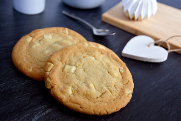 White chocolate chips cookies on black marble background