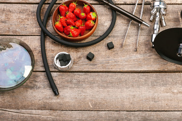 Parts of hookah and fruits on wooden background