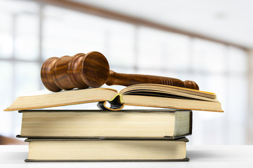 Wooden judge gavel on table, front close-up view