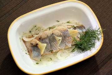 Herring fillet with onion lemon and dill.