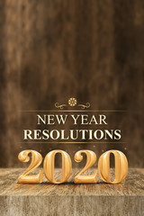 Gold shiny 2020 new year resolutions (3d rendering) at wooden block table and blur wood wall,Holiday greeting card,Mock up for display of your design or content for social media.