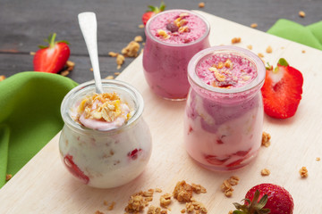 Healthy summer breakfast. Jar with granola, yoghurt and strawberry